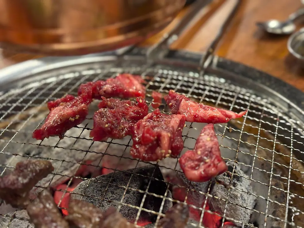 Table spread with soup and meat at Jowatso
