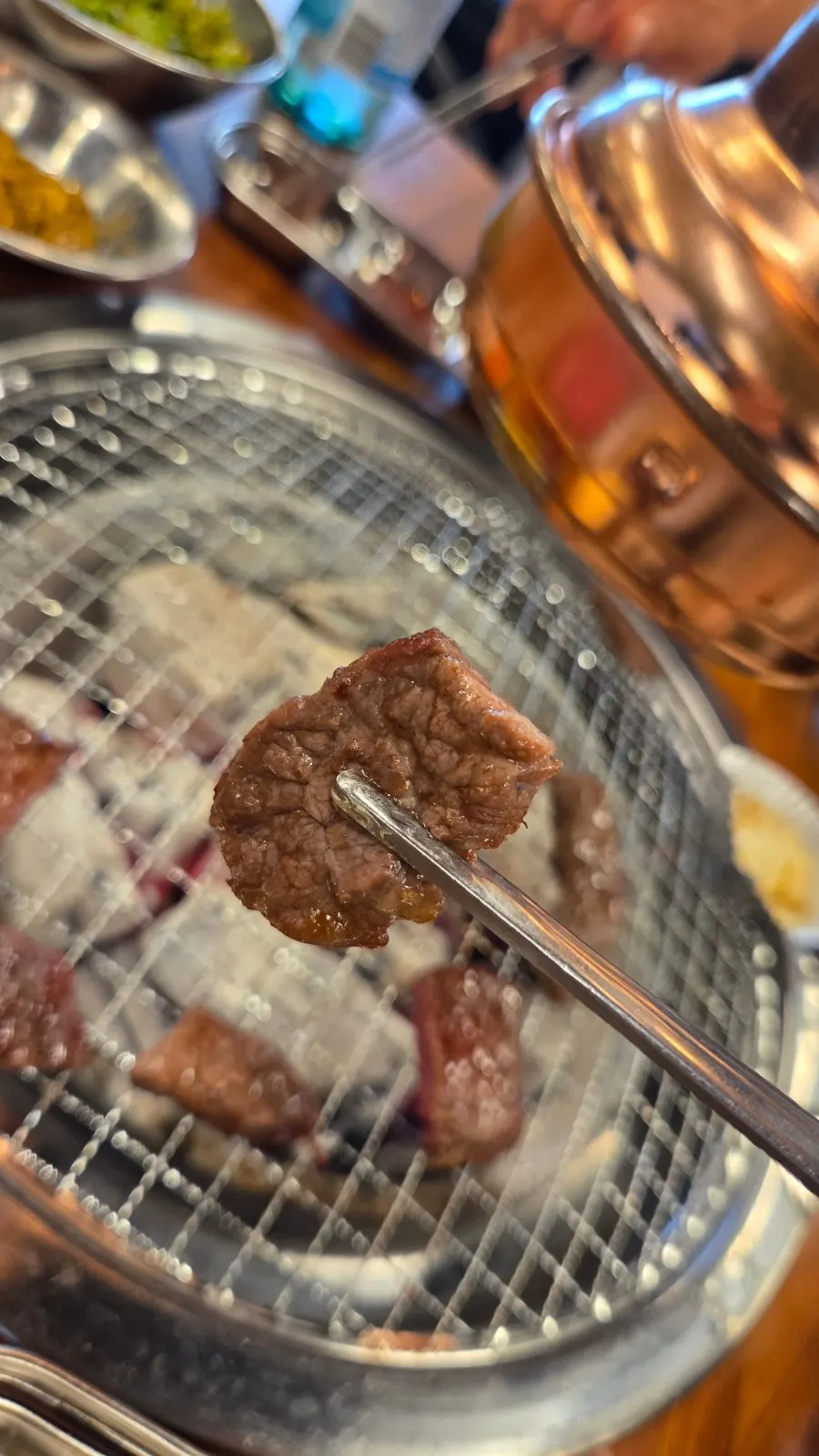 Beef slowly grilling over charcoal