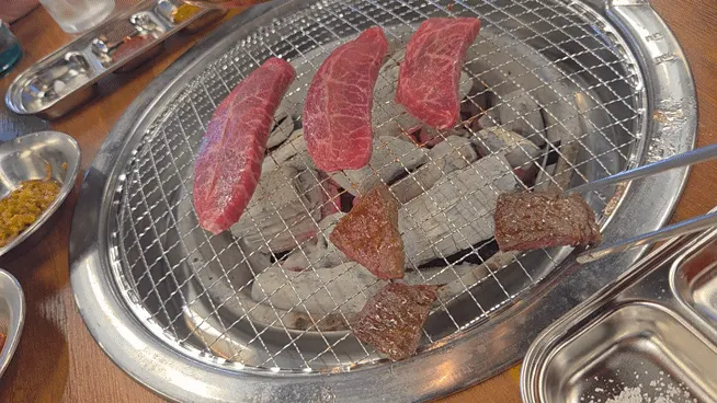 Grilled beef placed over charcoal