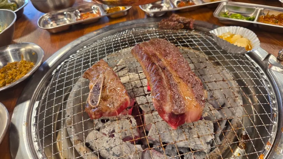 Beef short rib cooking over charcoal