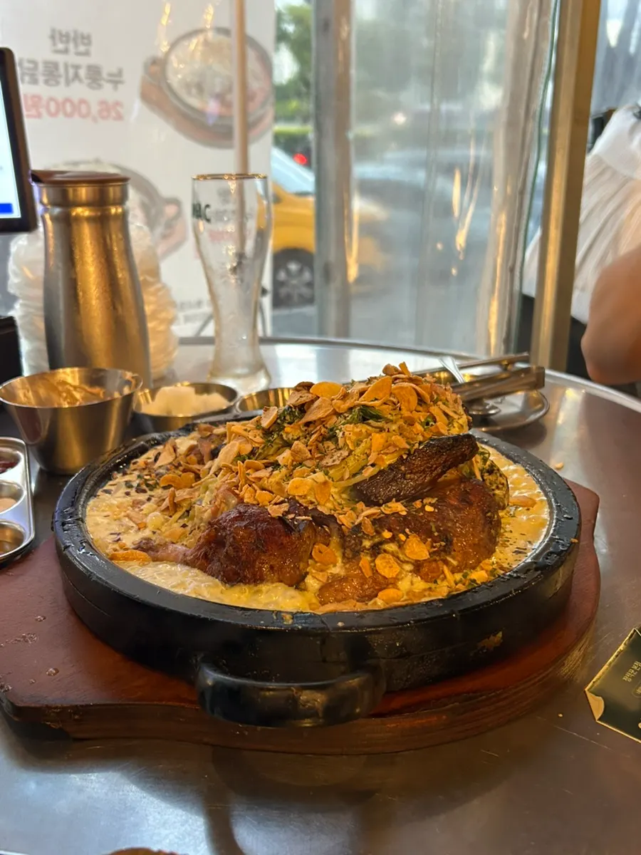 Cheongyang cream nurungji chicken served on a hot stone plate