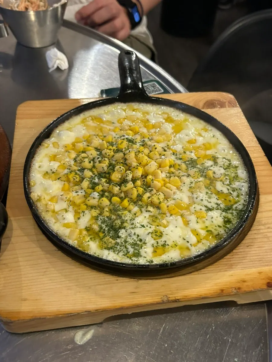 Corn cheese on a hot stone plate received for a receipt review