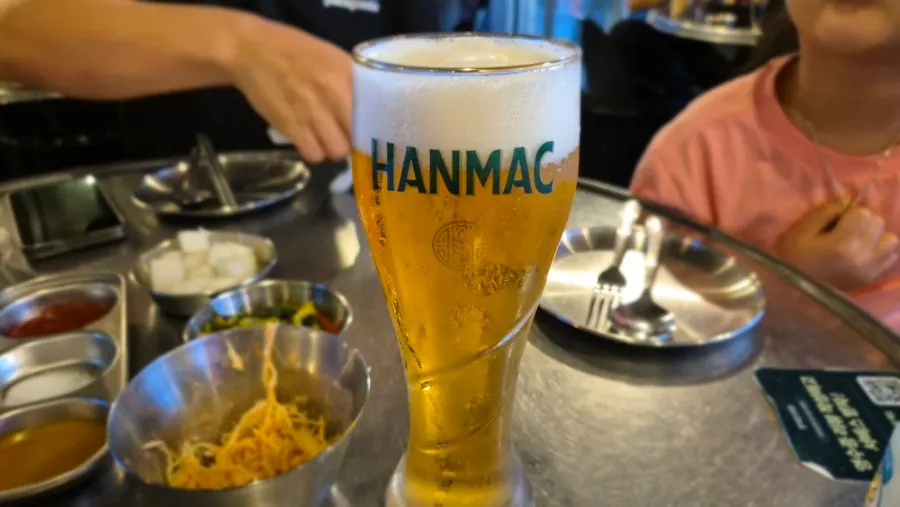 A cold draft beer set on an outdoor table