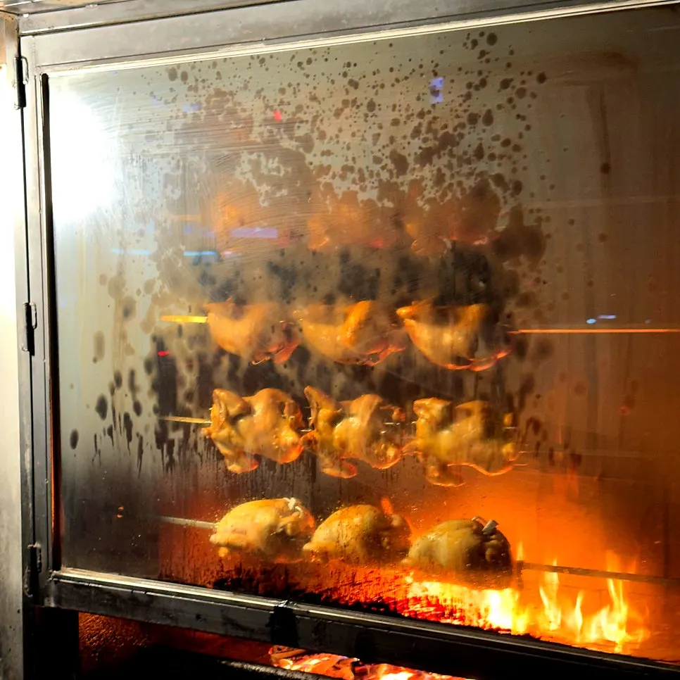 Wood-fired chicken grilling out front