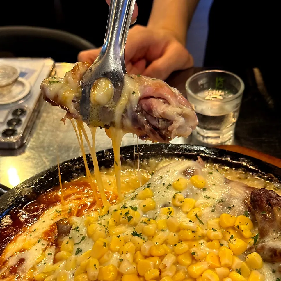 Tender chicken meat pulling apart with tongs
