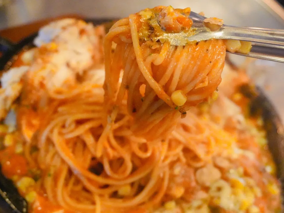 Rosé pasta noodles laid beneath the whole chicken