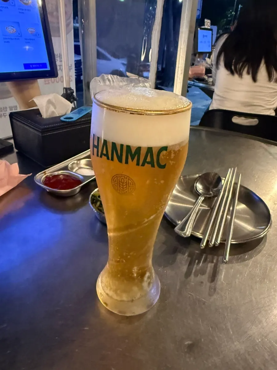 A glass of draft Hanmaek beer in outdoor seating