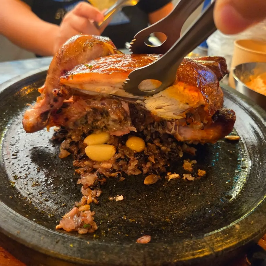 Table set with ordered herbal and rosé scorched-rice chicken