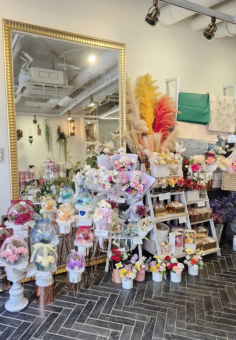 Display shelf of pink and purple bouquets