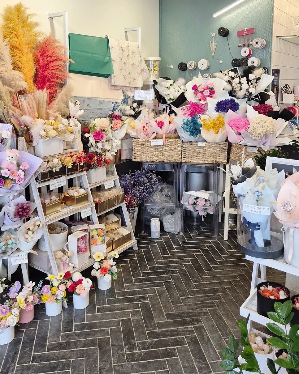 Store display featuring a bouquet with a small doll tucked in