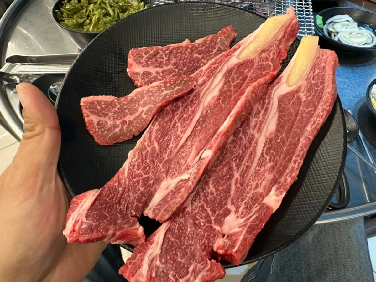 Hanwoo ribeye grilling over charcoal at Jangpro Hanwoo Galbitsal