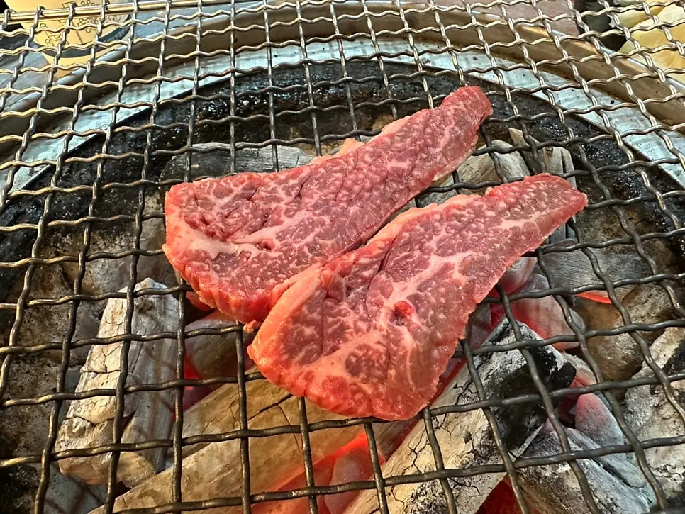 Ribeye grilling over strong charcoal heat