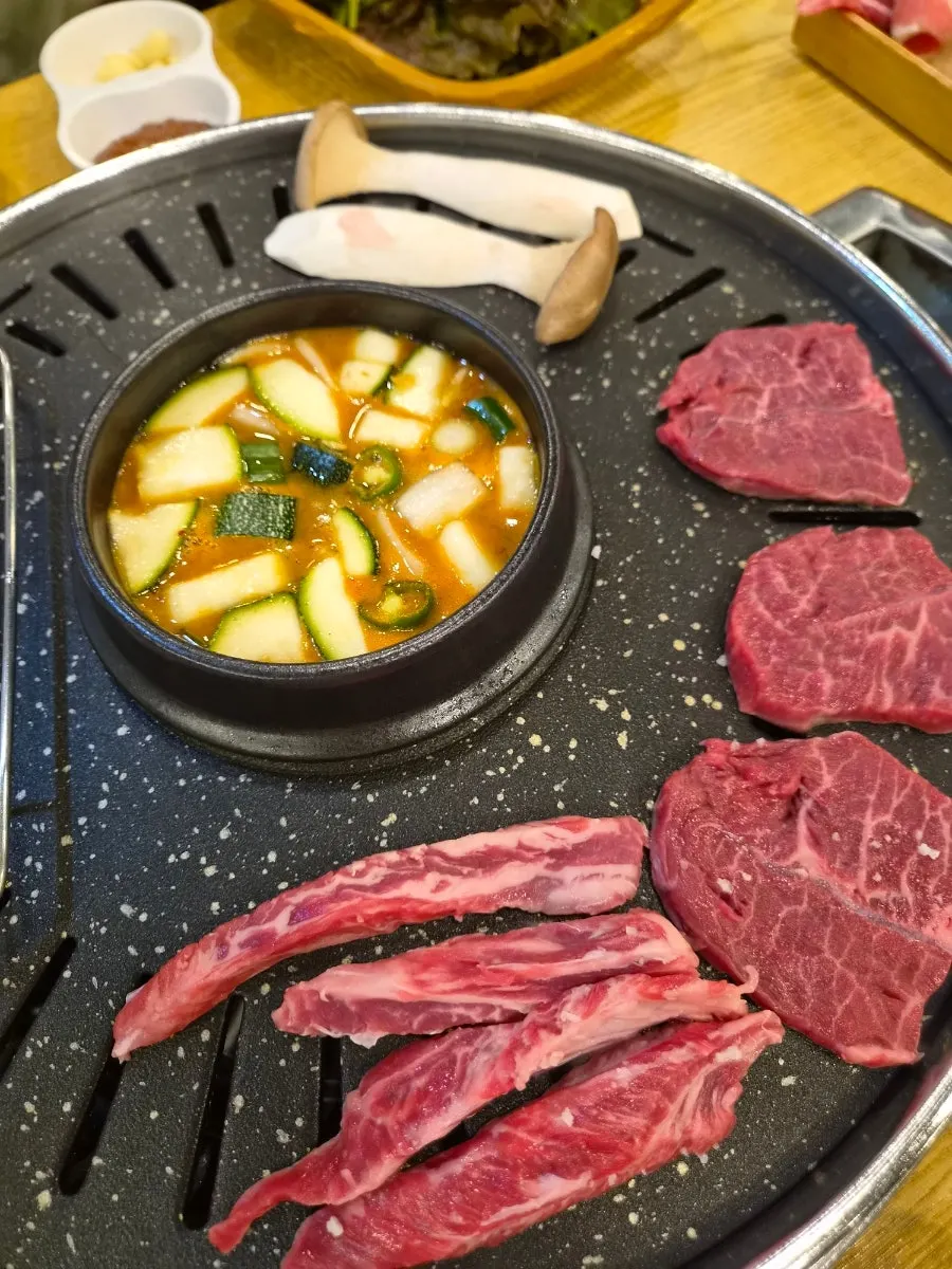 Meat and side dishes at the table set for two