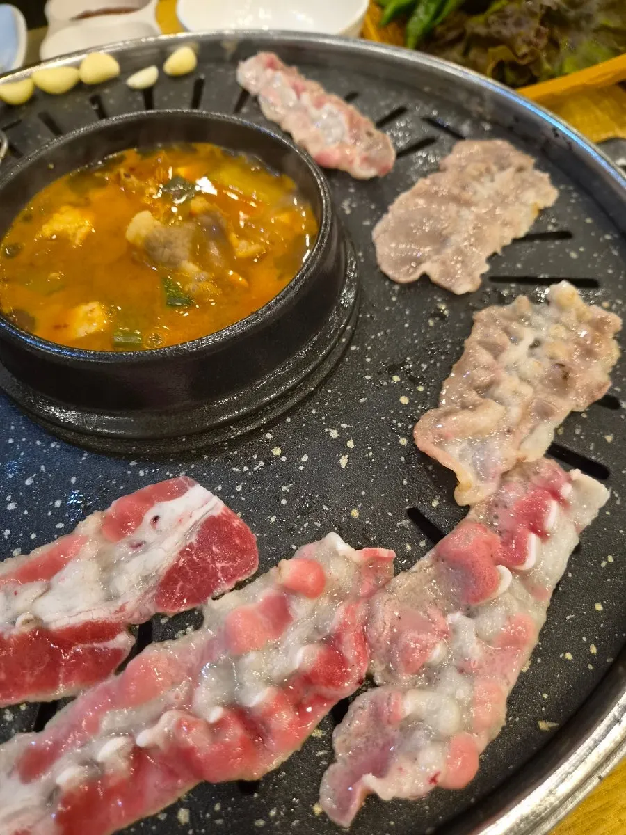 Unlimited chadol-doenjang jjigae simmering with added beef brisket