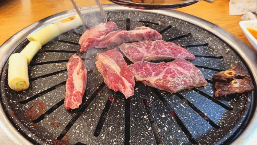 Beef grilling on a coated pan