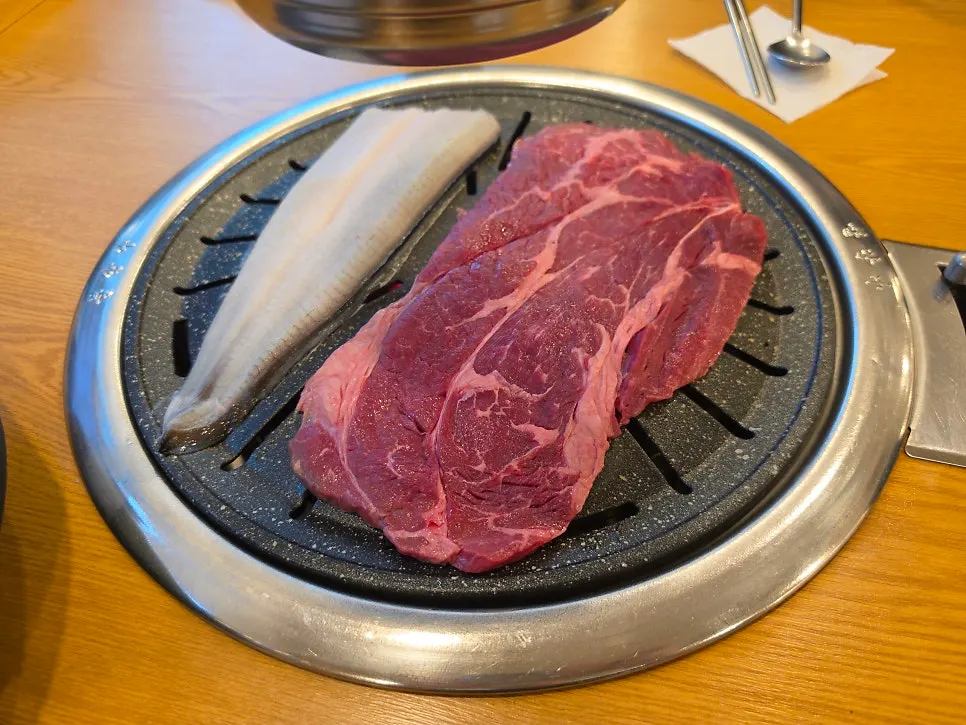 A large piece of beef placed on the grill