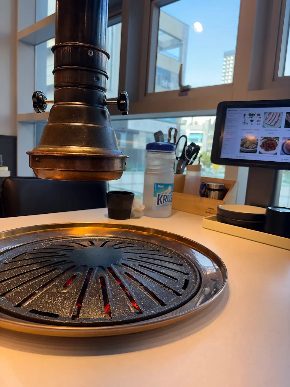 Hot charcoal added to the table grill