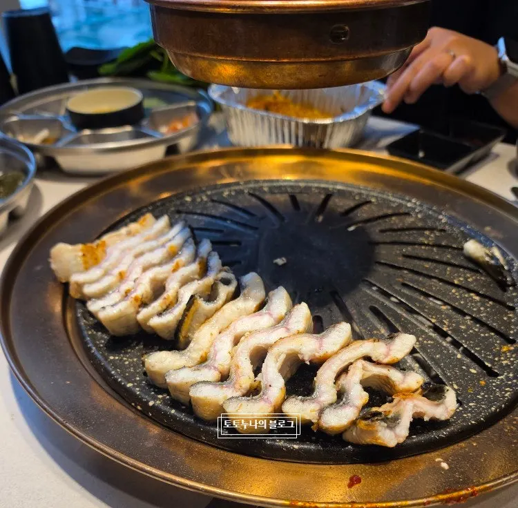 Freshwater eel turning golden-brown on the grill