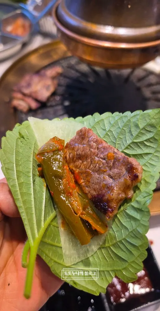 Dipping grilled beef into sauce