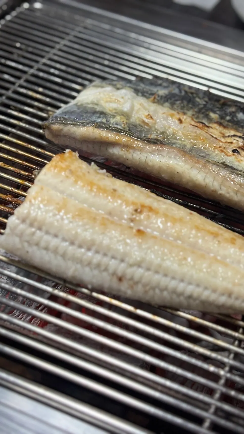 Eel placed back-down and salted on the grill