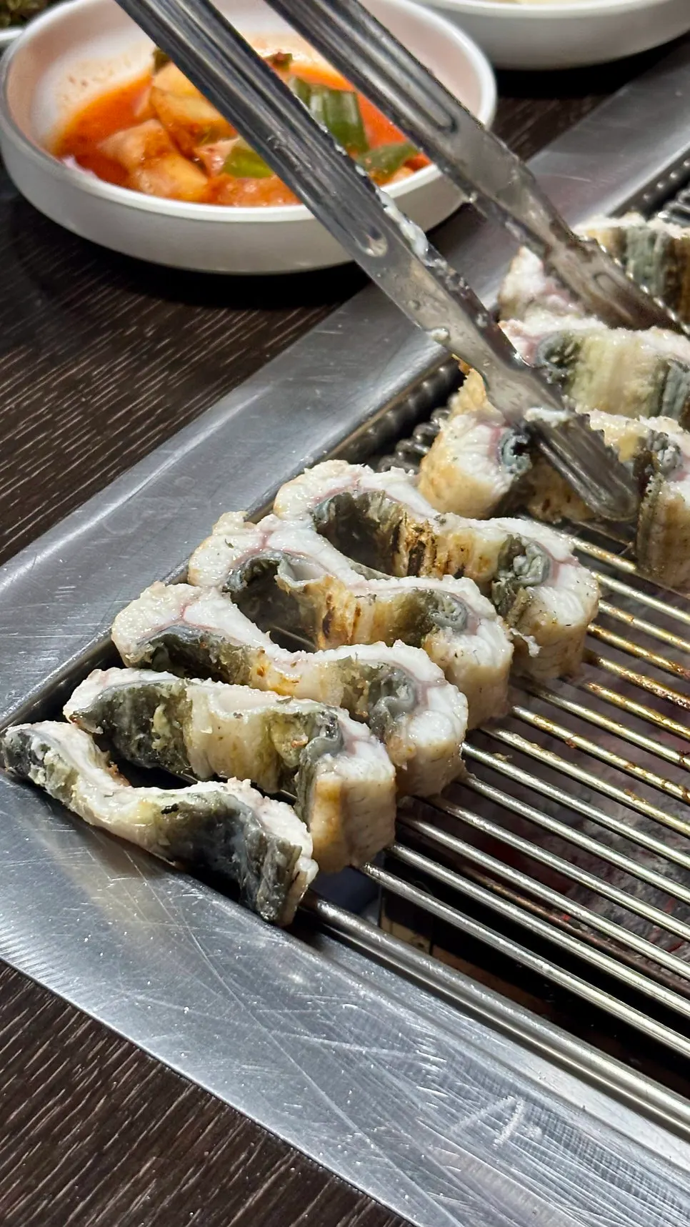 Eel being flipped and grilled
