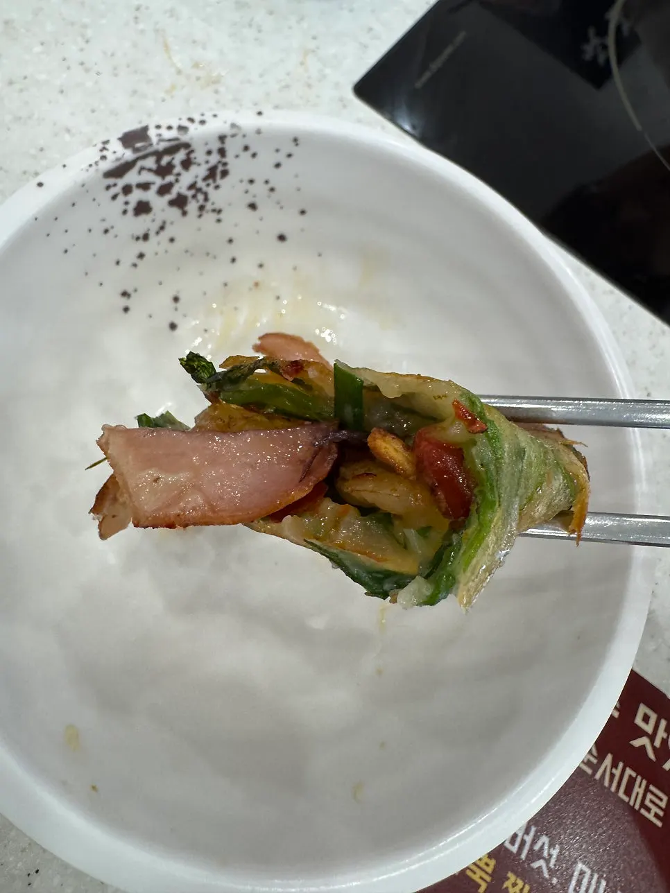 Cross-section of the pancake packed with whole shrimp and seafood