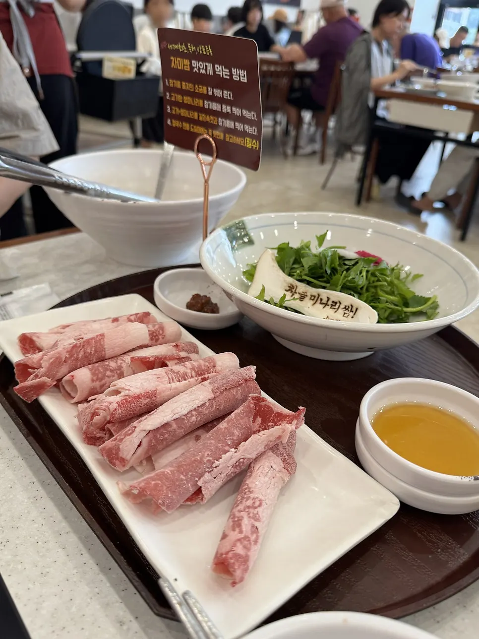 A chadol wrap piled with minari and mushrooms