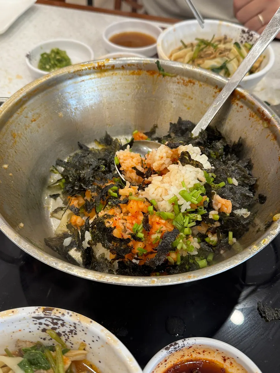 Kkakdugi fried rice being stir-fried in the pot