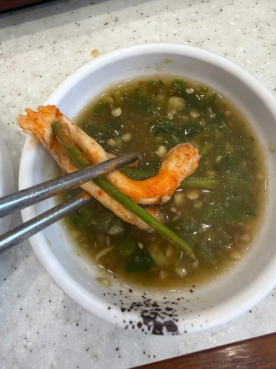 Shabu-shabu meat dipped in sesame oil sauce