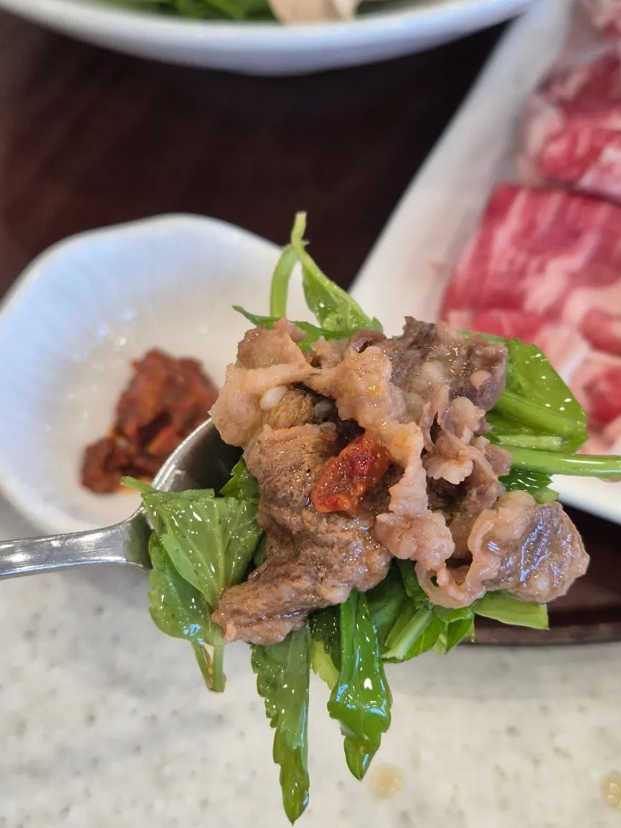 Brisket minari wrap dipped in sesame oil sauce
