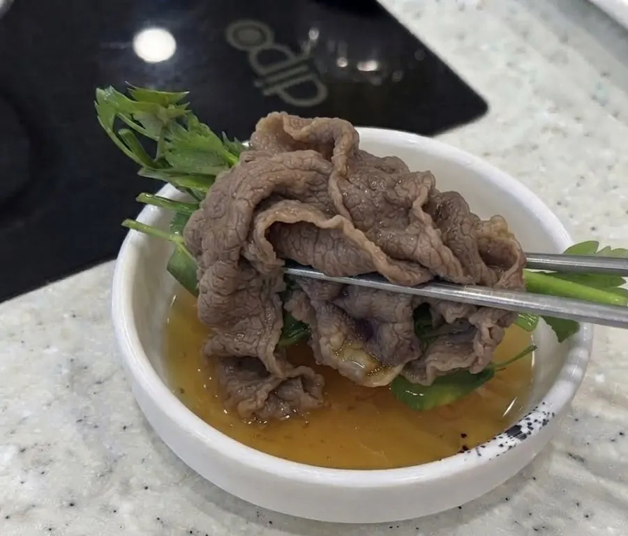 Blanched brisket wrap topped with minari