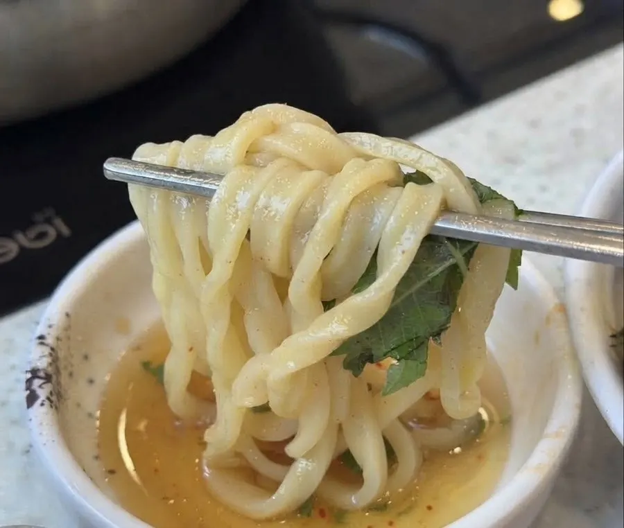 Chadol minari wrap dipped in sesame oil sauce