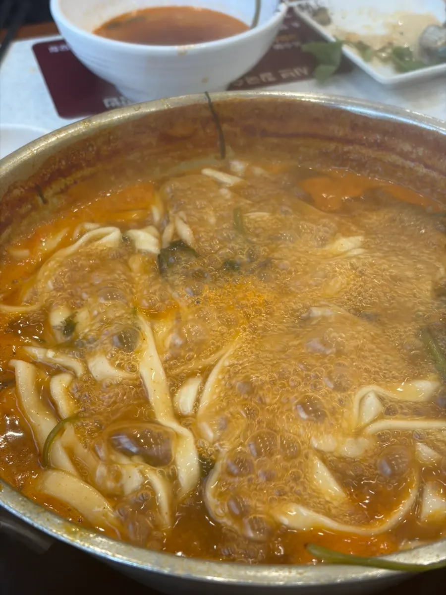 A bowl of kalguksu with rich broth