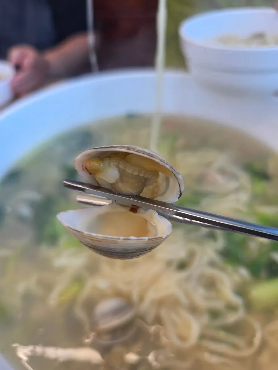 Pot with three servings of clam kalguksu