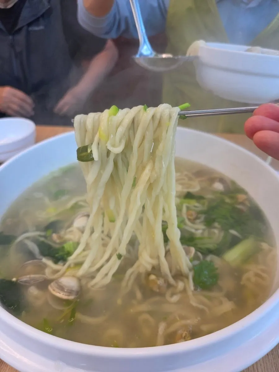 Noodles and clams scooped up together