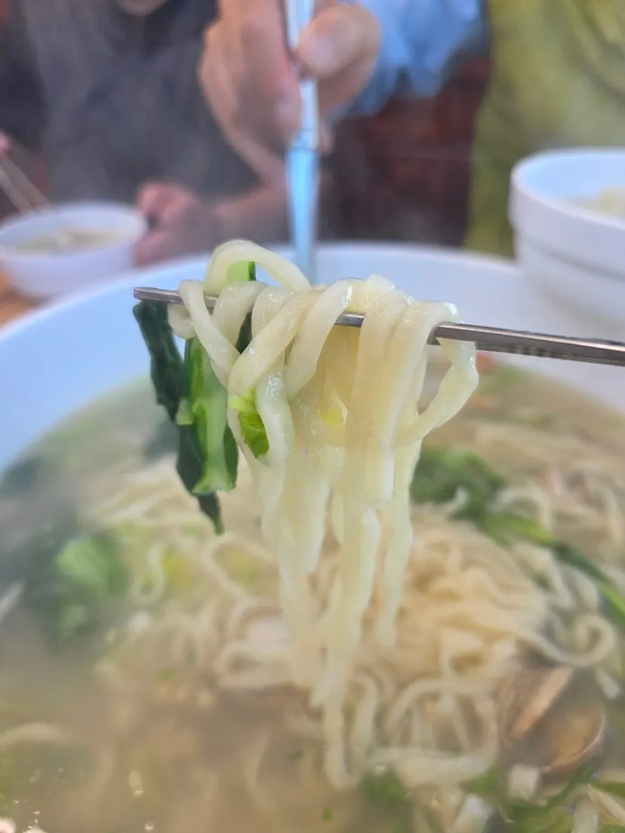 A bowl of clam kalguksu being eaten