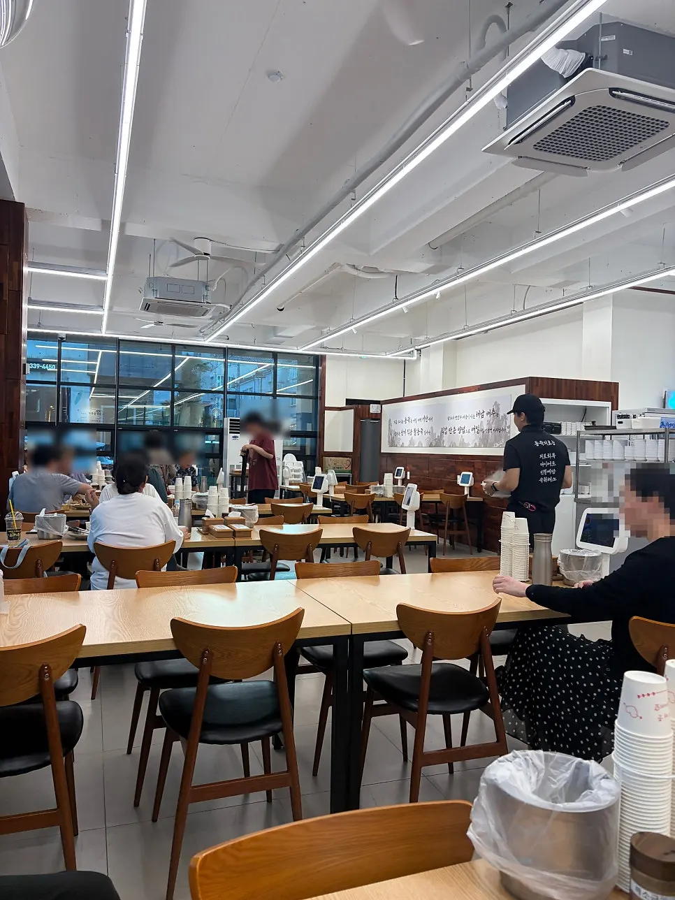 Restaurant interior seating packed with customers