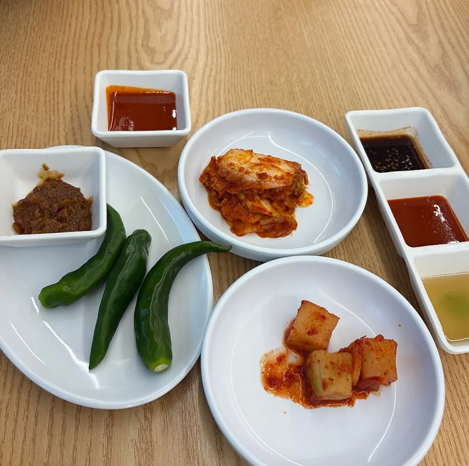 Makgeolli served by the glass alongside side dishes