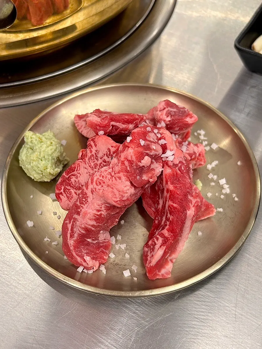 Raw hwangje beef short rib showing marbling