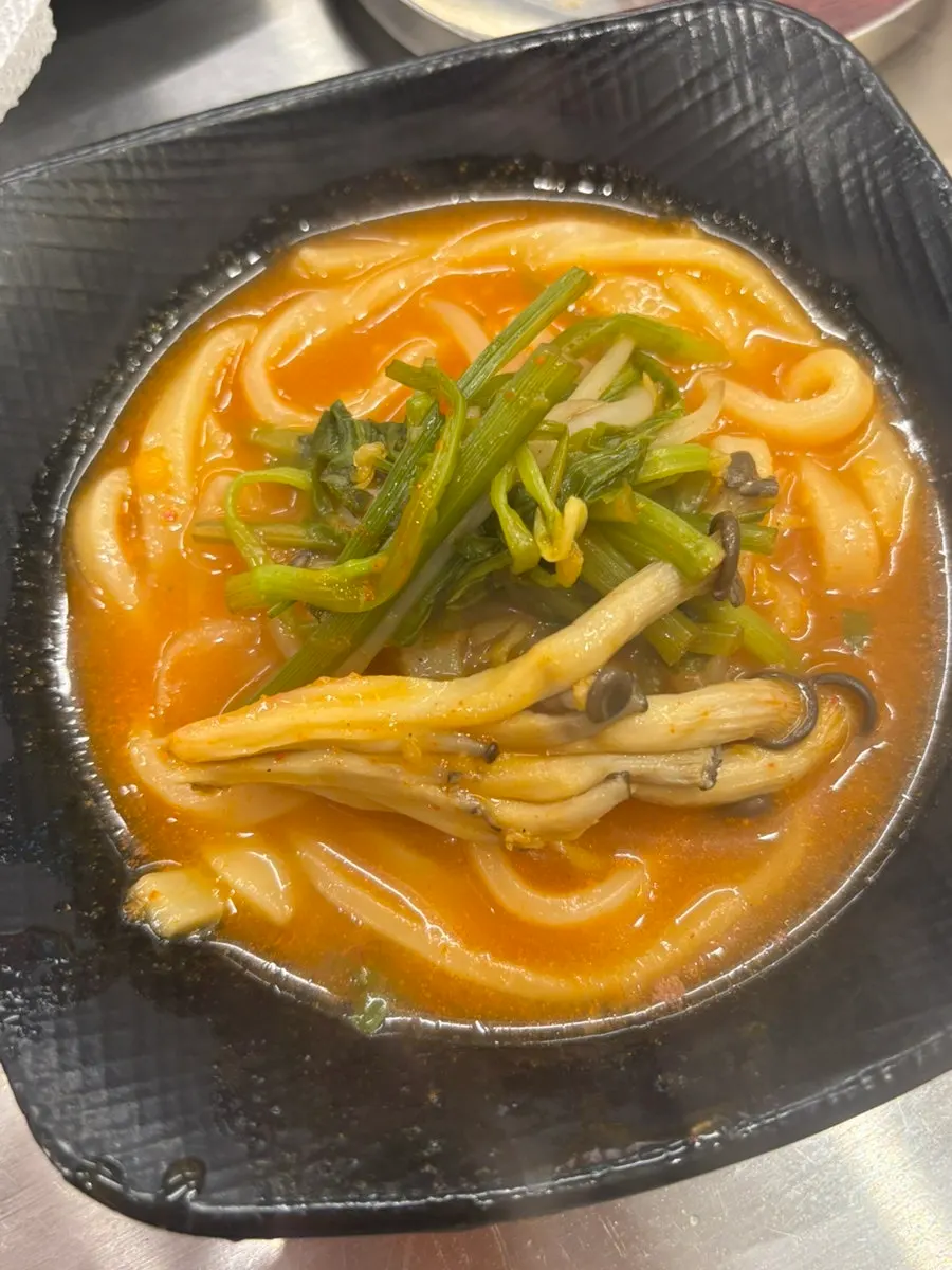 삼겹살과 칼국수가 함께 놓인 테이블
