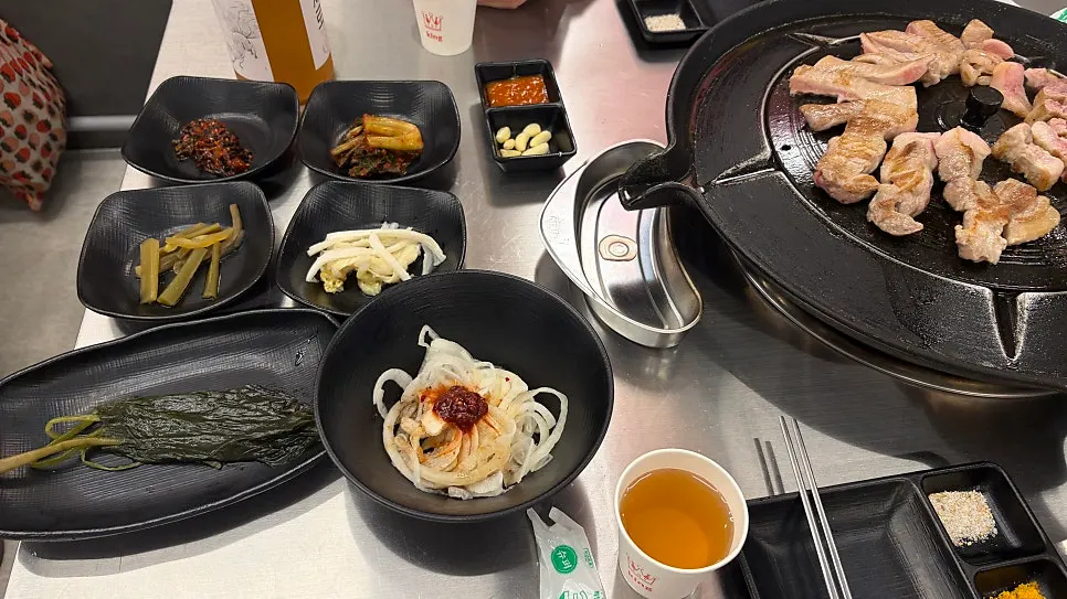 Sweet pumpkin and side dishes grilling together on the iron lid