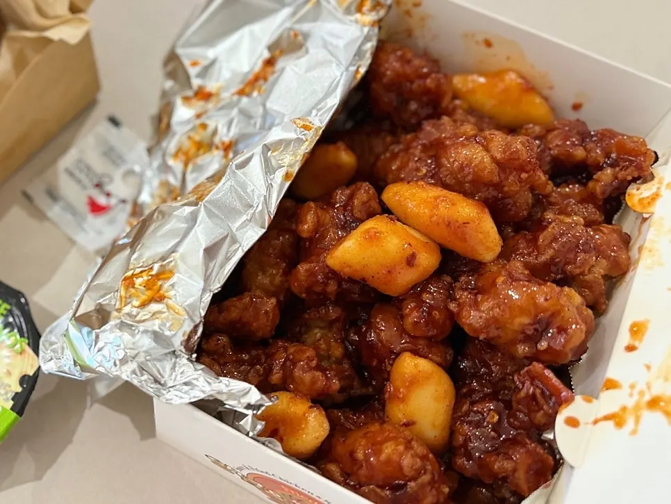 Close-up bite of crispy sauce-coated dakgangjeong