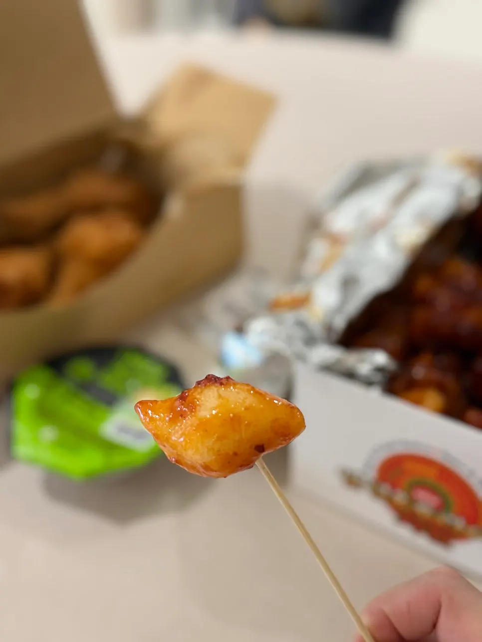 Takeout box of four meaty drumsticks