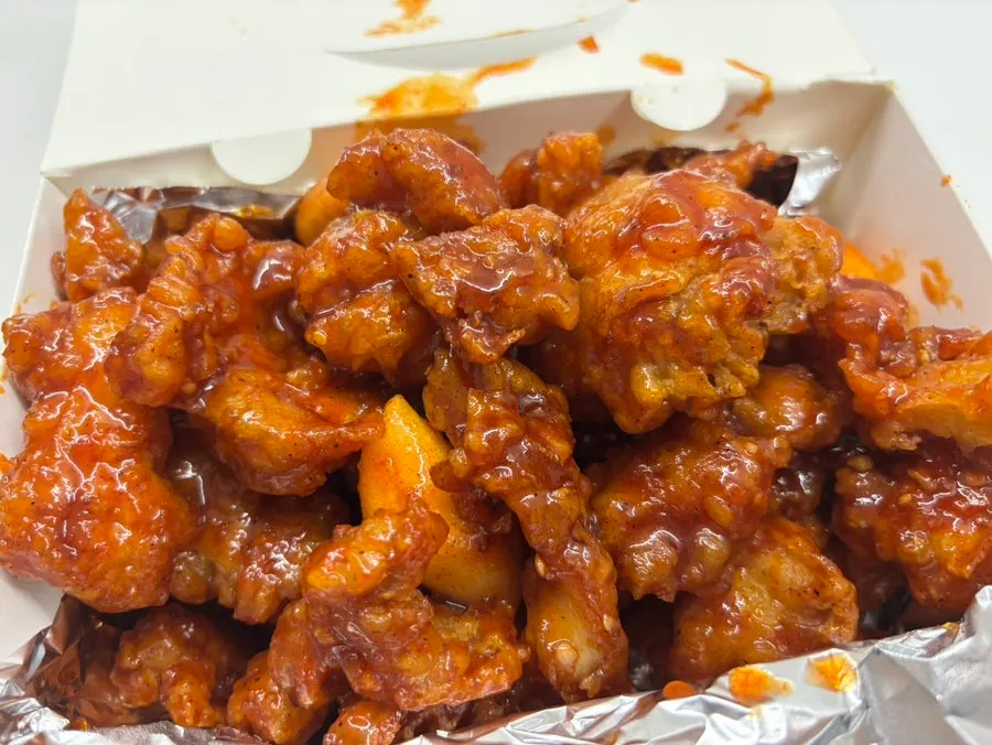 Box filled with boneless dakgangjeong pieces