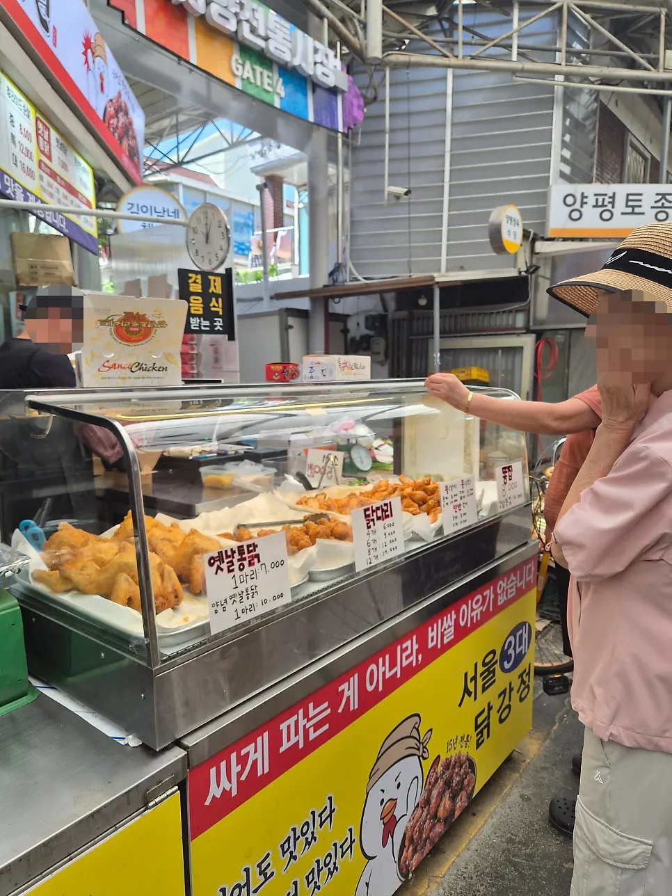 Market customers stopped in front of the chicken shop