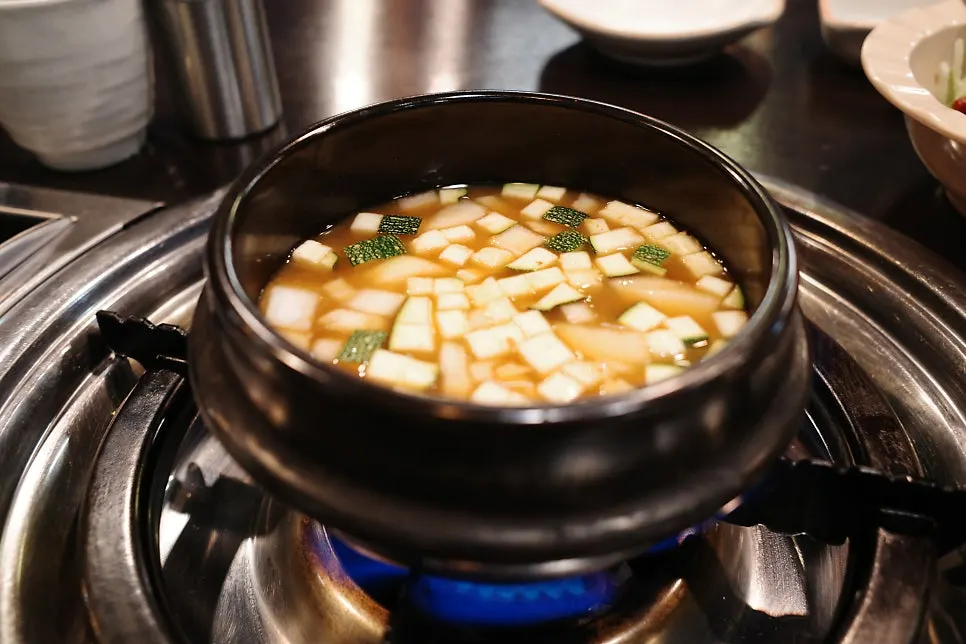 Complimentary doenjang-jjigae on a separate tabletop burner