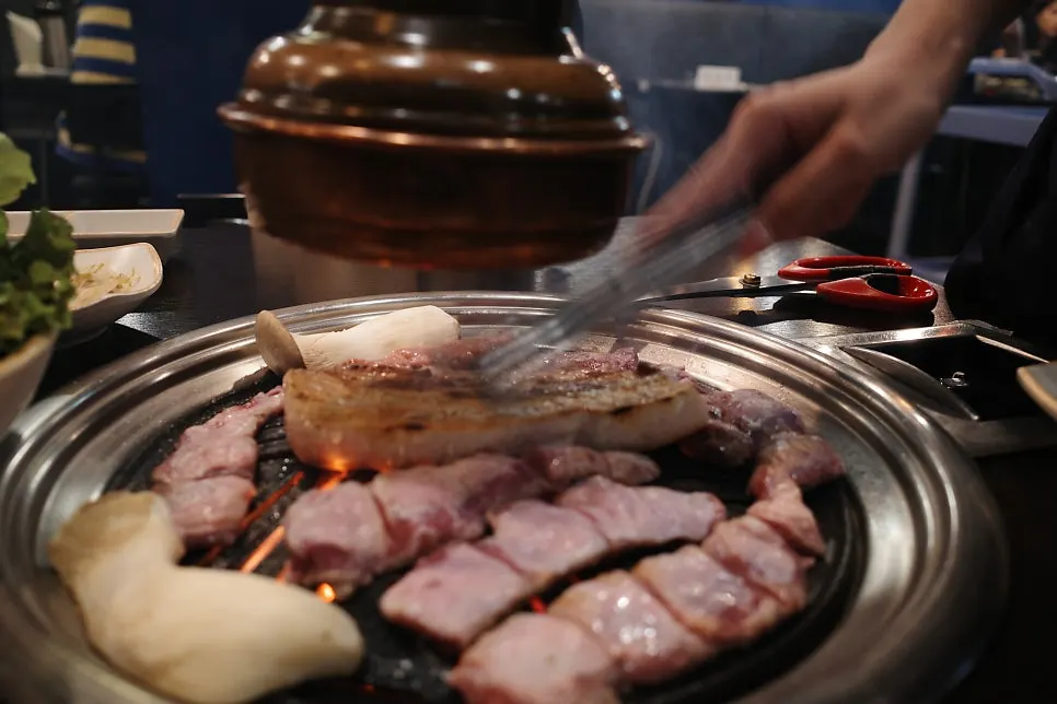 Meat cooking on the charcoal grill