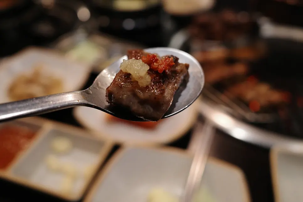 A bite of whole skirt steak served with sauce