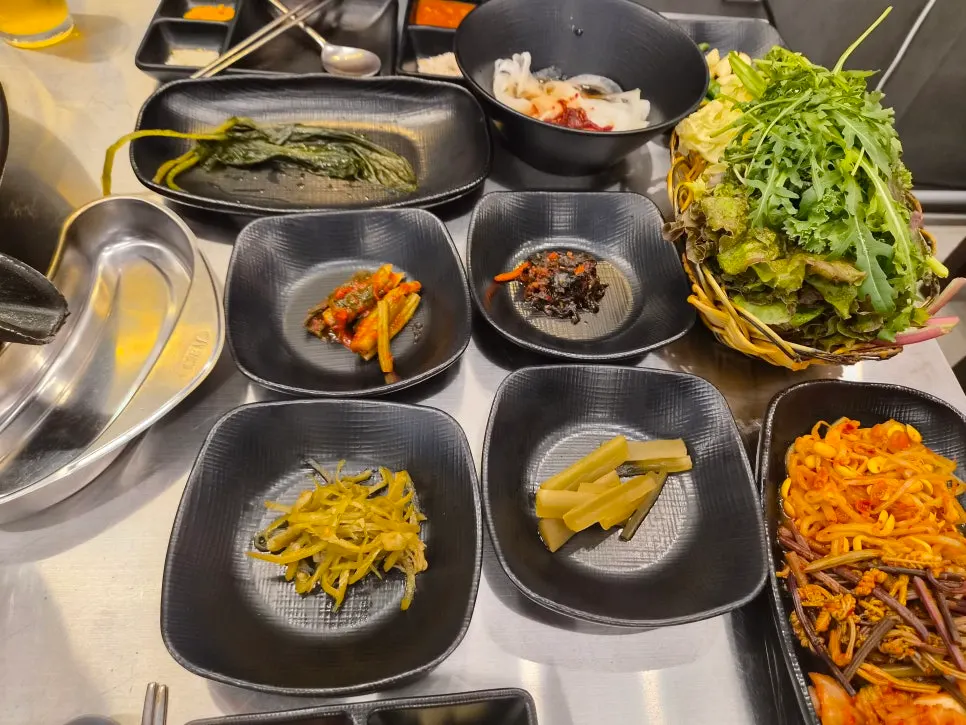 Kimchi, seasoned bean sprouts, and scallion salad side dishes