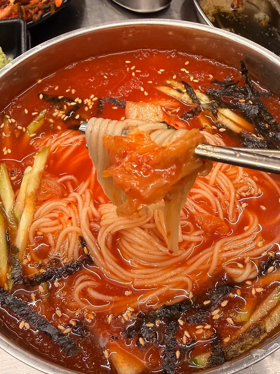Kimchi noodle soup topped with kimchi